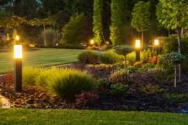 picture of beautiful backyard after exterior lighting installation at dusk