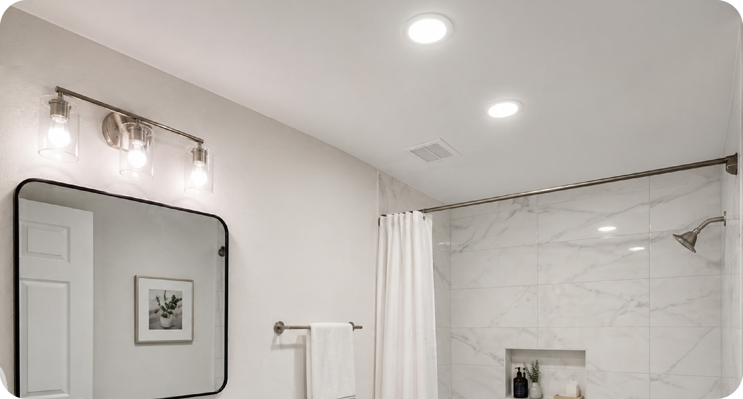 Bathroom vanity with recessed lighting and wall sconces