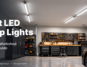 Bright LED shop lights illuminating a modern garage workshop with a workbench, tools, and parked car